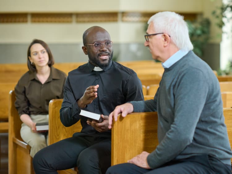 Priest having a conversation with a parishioner