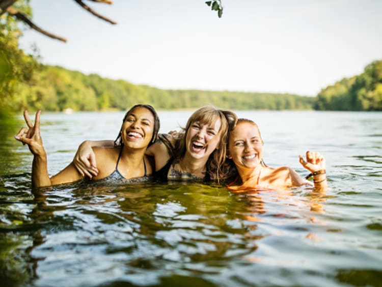 Friends swimming in lake