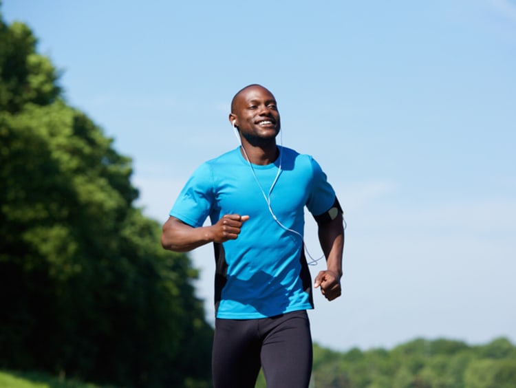 Happy man running in a park