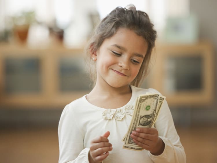 Little girl holding money