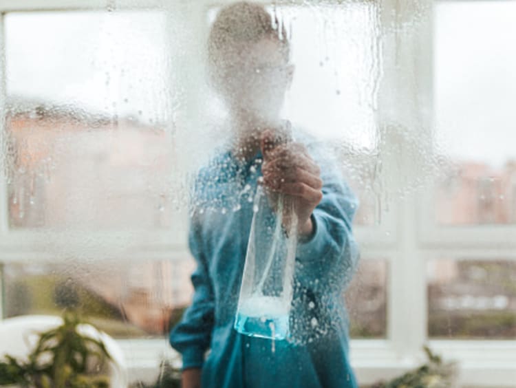 Man cleaning glass window