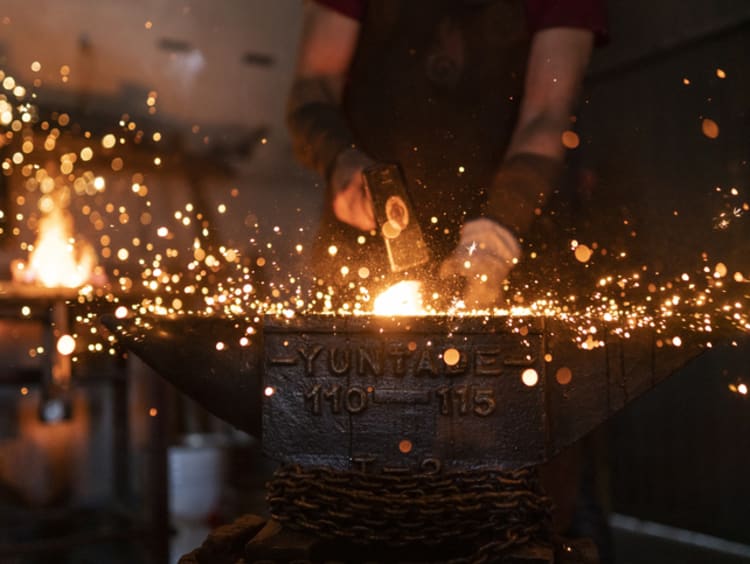 Man using his God given talents forging in his workshop