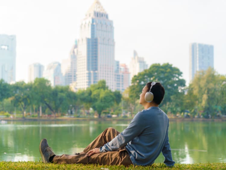 Man sitting and listening in park