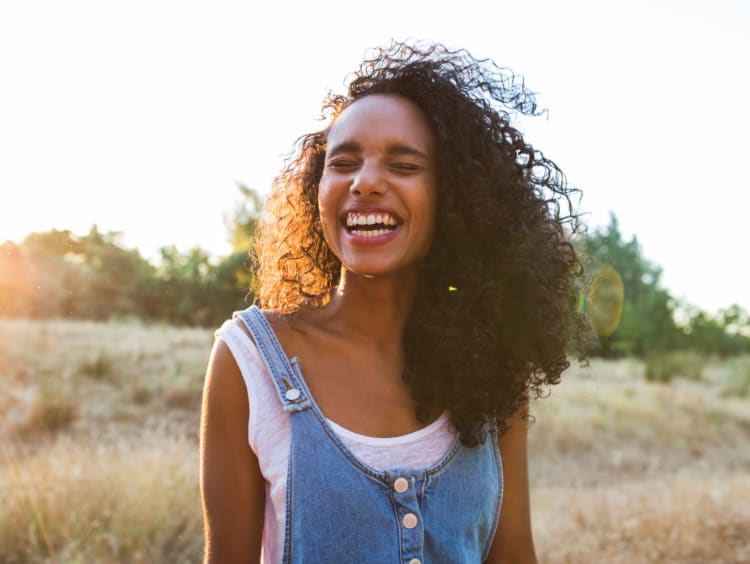 Woman enjoys a sunny day in an open field