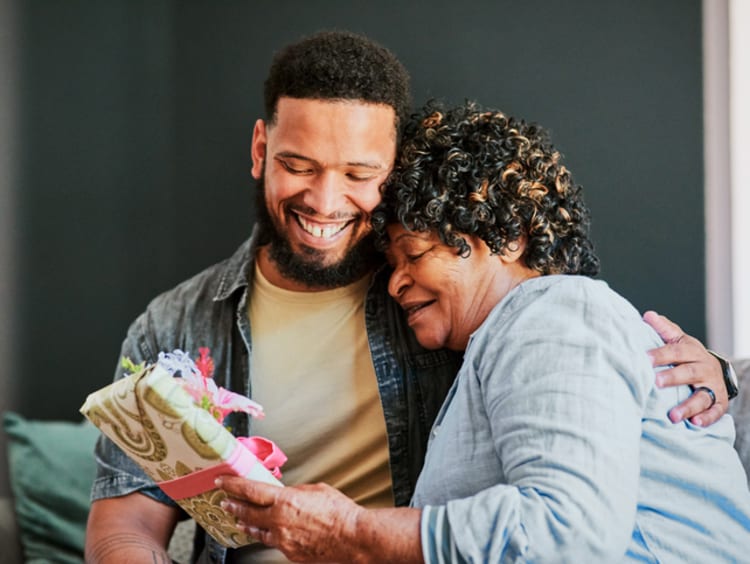 Man giving a gift to older woman