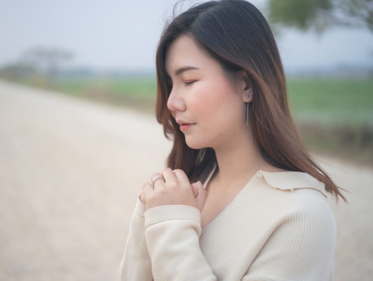 Woman praying and relying on God