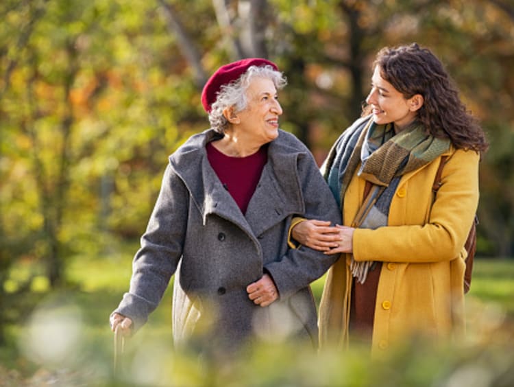 Woman listening to grandmother on walk