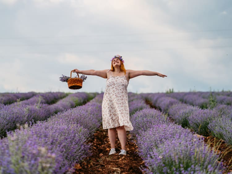 Woman celebrating God's creation in lavender field