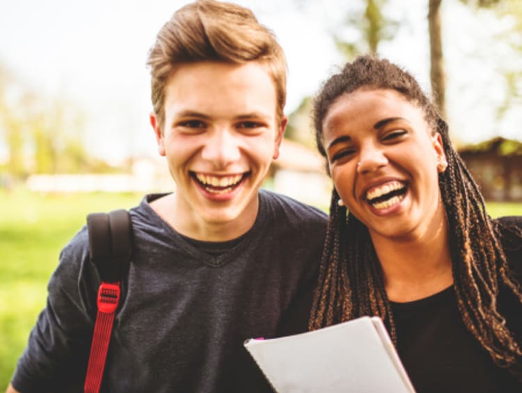 Two college students with cheerful hearts smiling