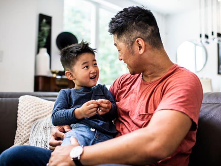 Father having conversation with young son about the power of our words