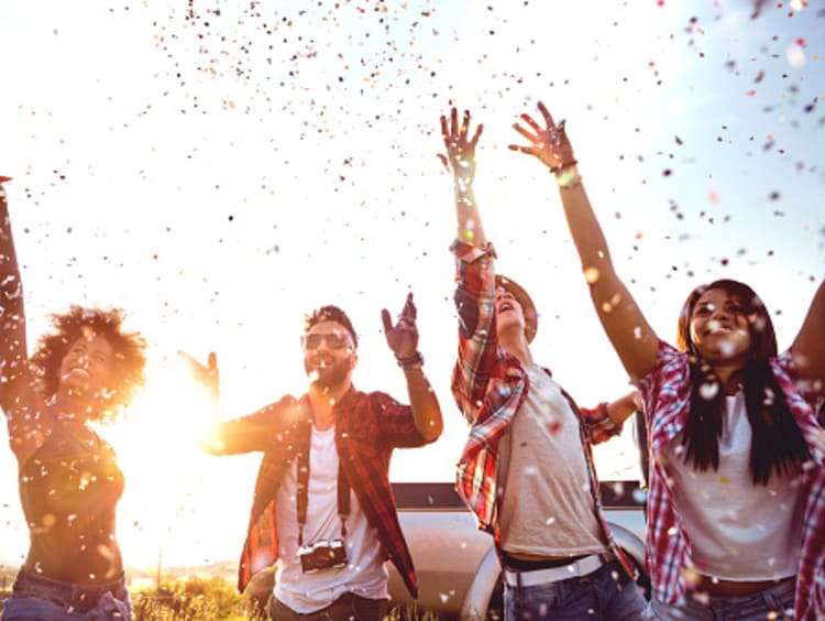 Friends celebrating and throwing confetti