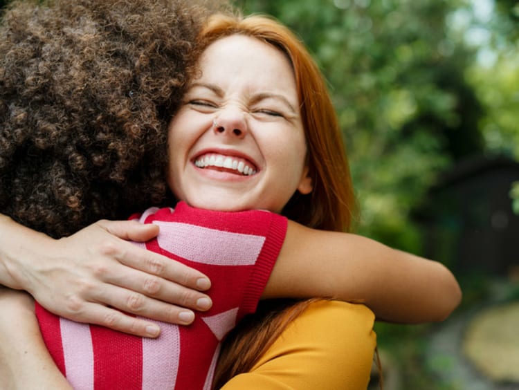 girls hugging and smiling