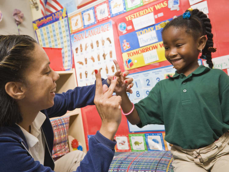 ESL teacher working with young student