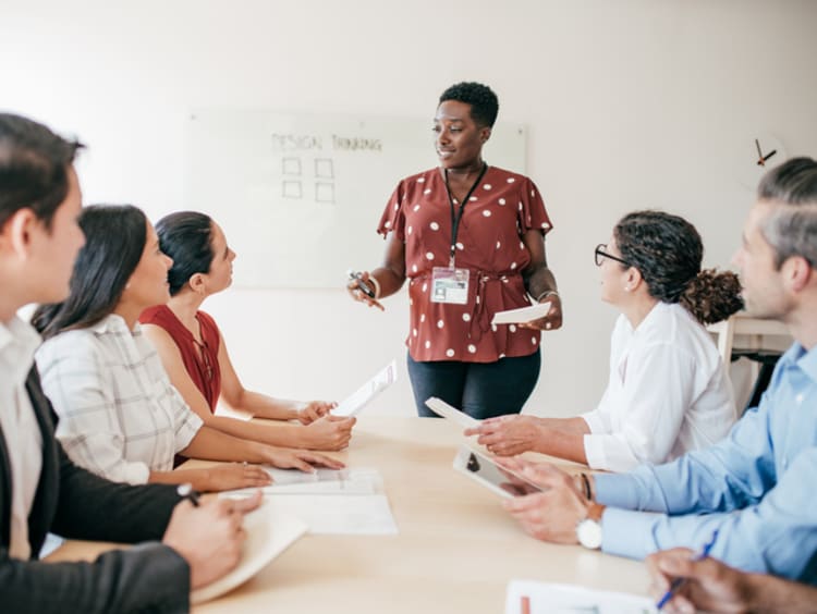 Female educational consultant talking with group of teachers