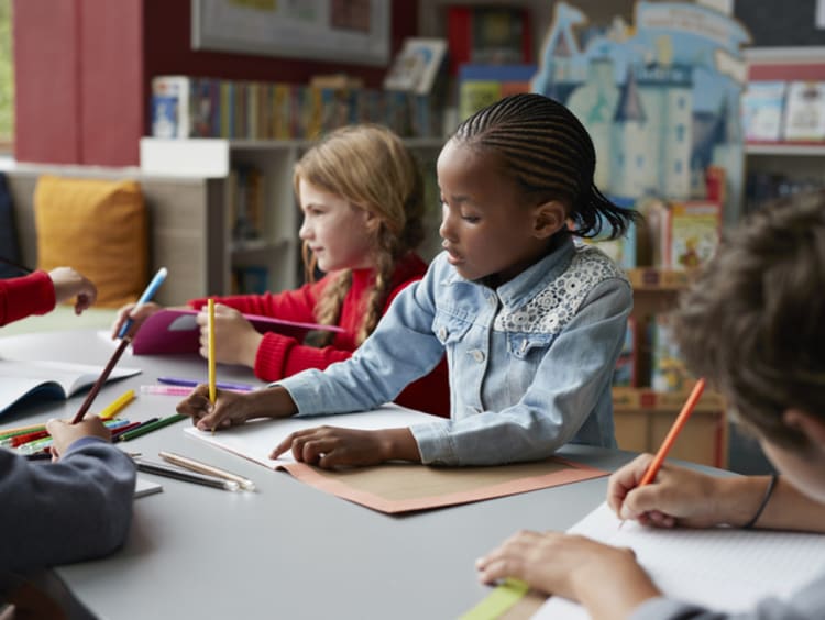 young students drawing in school