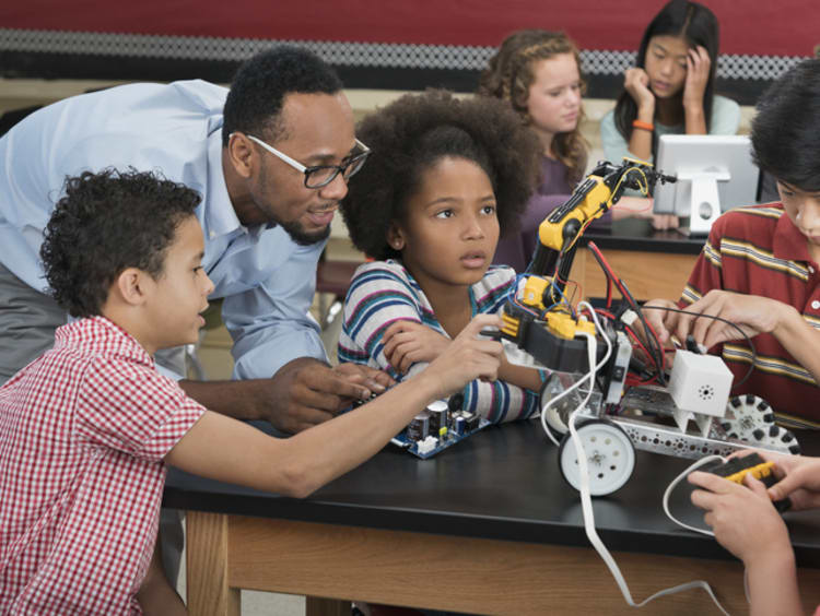 Black STEM educator teaching kids science