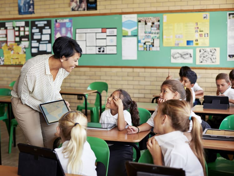 A teacher consulting with her students