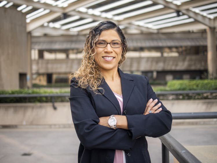 female school administrator smiling on school campus