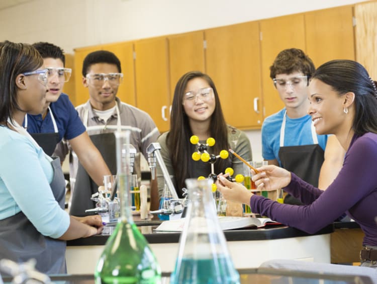 A high school teacher teaching chemistry to her students