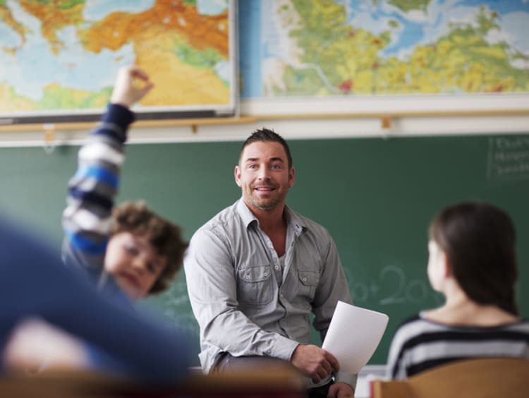 male teacher speaking to students