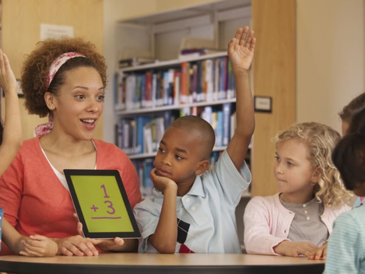 Black mathematics teacher with young students