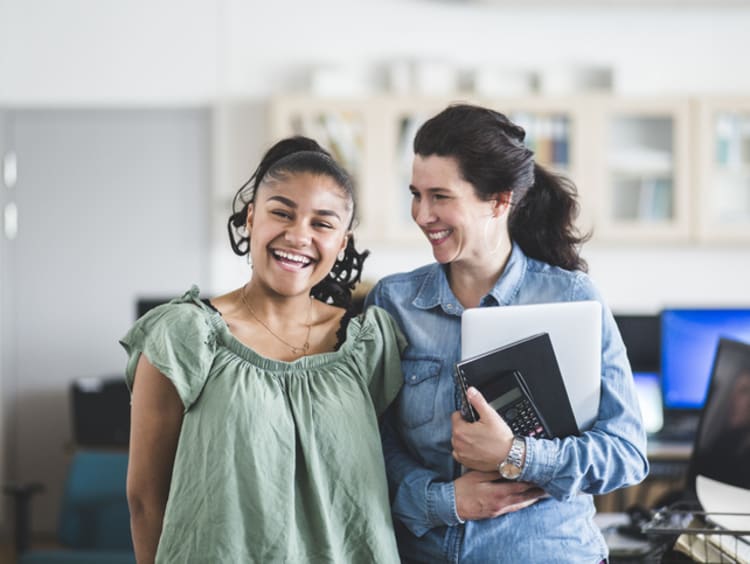 A teacher and student laughing together