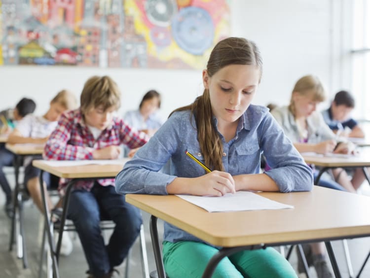 young students taking test in classroom