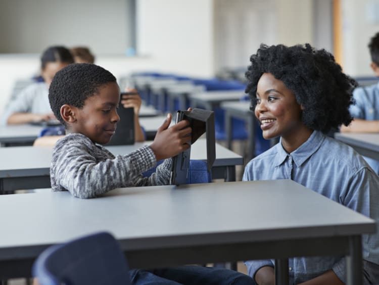 female teacher working with young student using social-emotional learning strategies