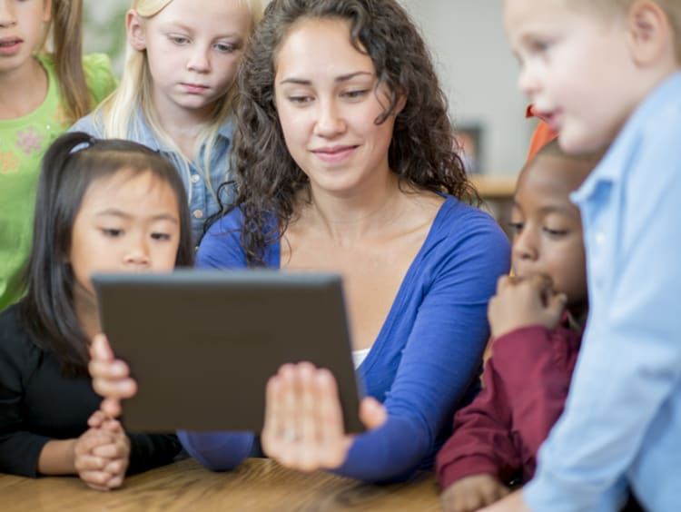 female teacher using game based learning techniques in classroom