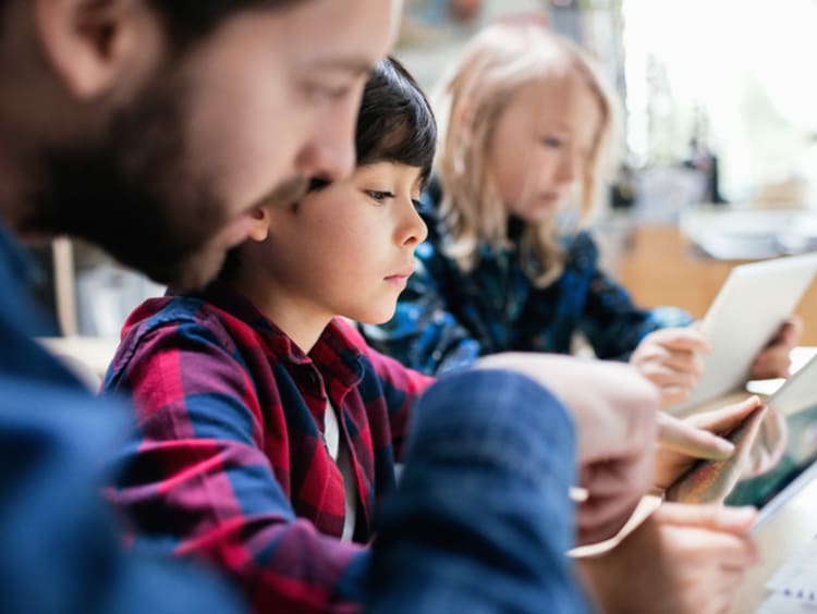 Teacher helping student with ipad and accessing their class information