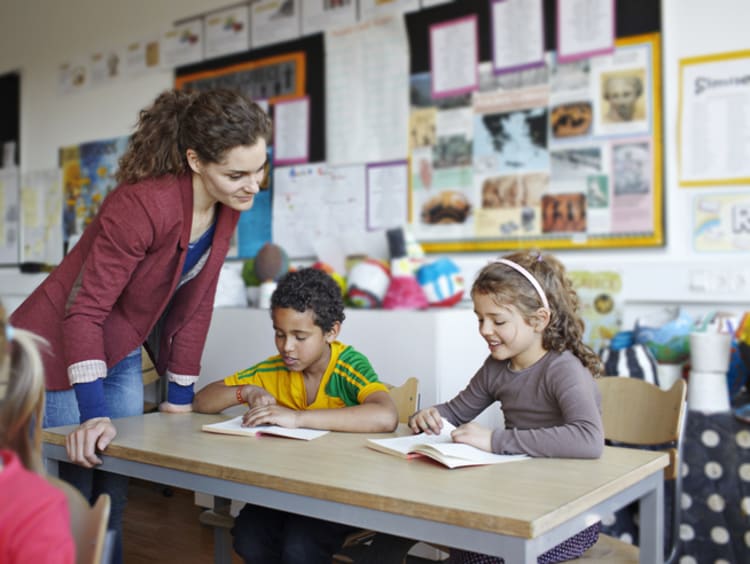 female teacher working with young students