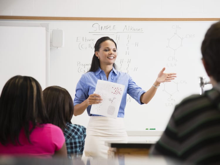 Female teacher speaking in front of class