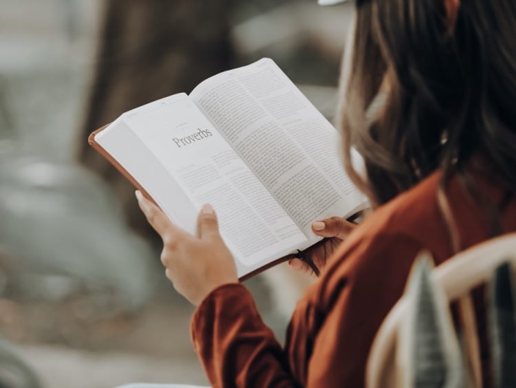 Woman reads Bible intently