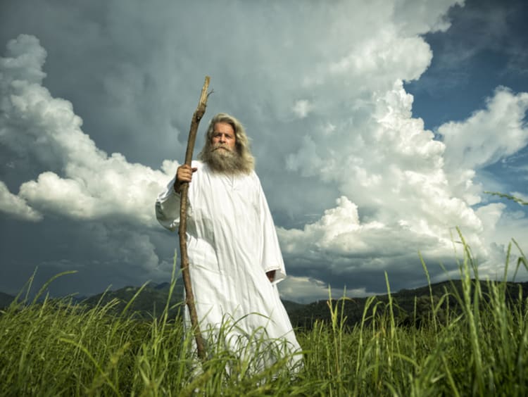 God walking in grass field 