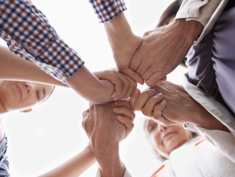 Group of hands clasped in prayer