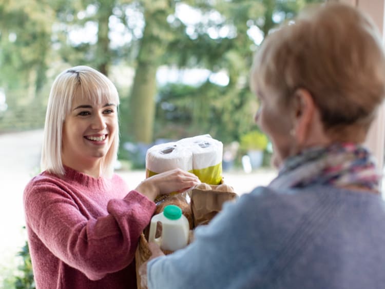 Woman showing God's goodness by helping a neighbor