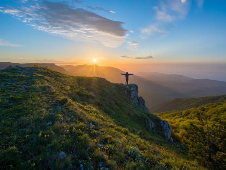 Person standing on top of mountain