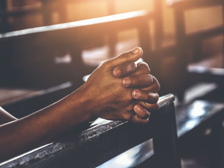 Hands clasped in prayer