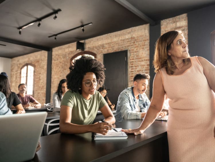 Woman helping student in classroom