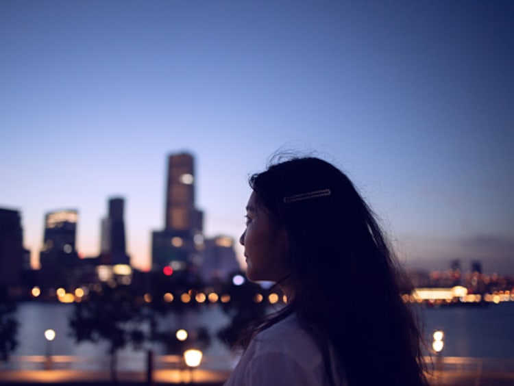 Woman looks out over a city