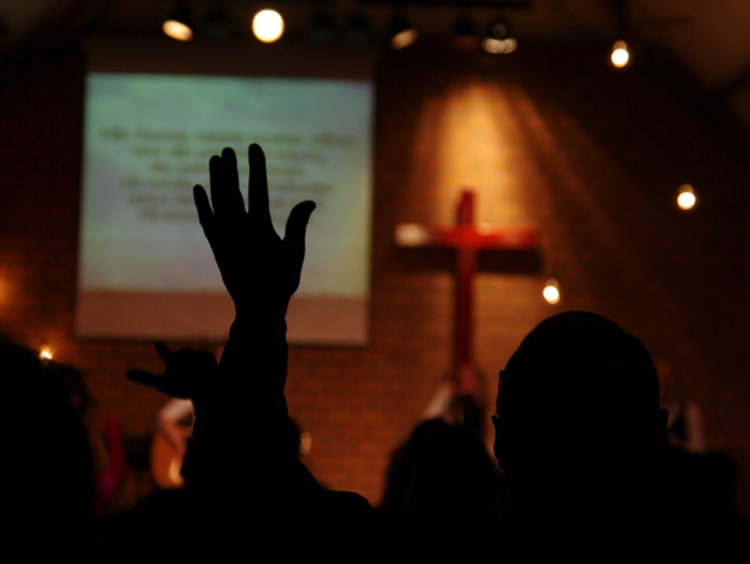 Worshipping in church with hand in the air