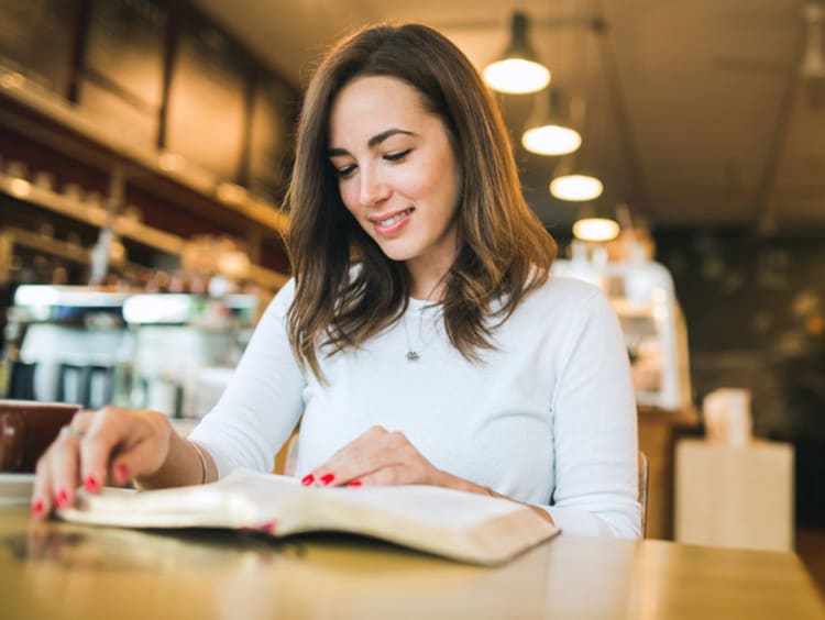 Girl doing Bible Study at a coffee shop