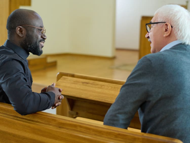 Pastor talking with a male member of the congregation