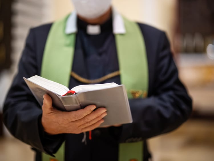 priest reading bible during congregation 