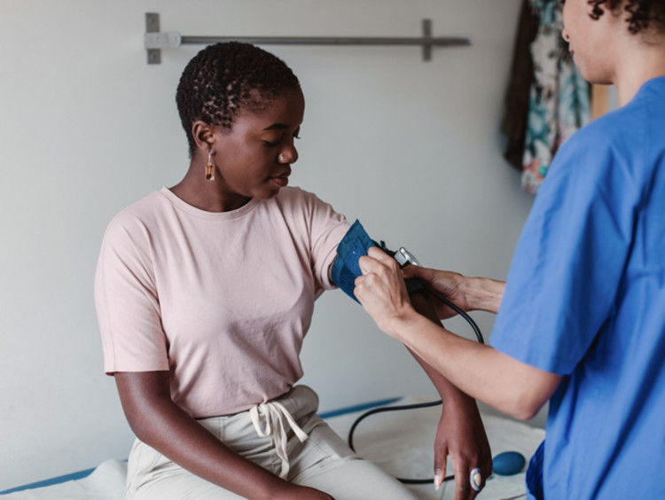 a nurse taking the blood pressure of a patient