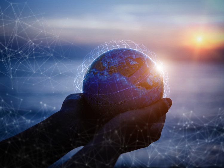 Cupped hands holding animated globe at sunset