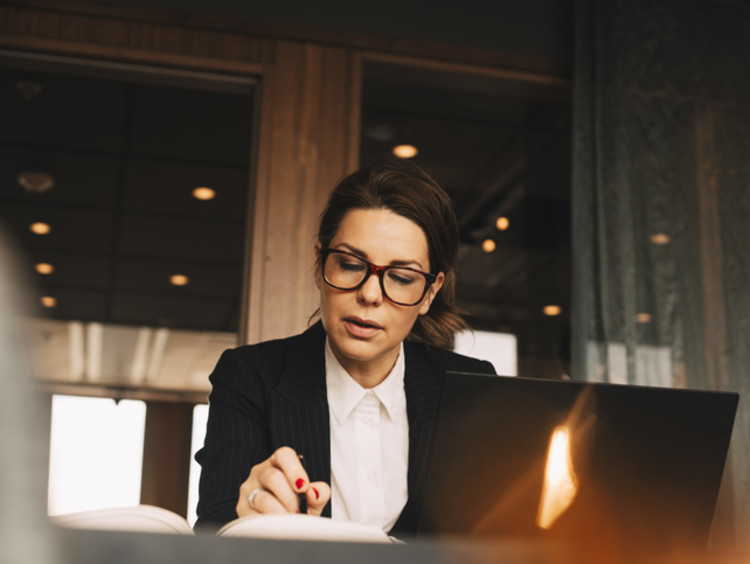 Lawyer sitting at desk with pen and book