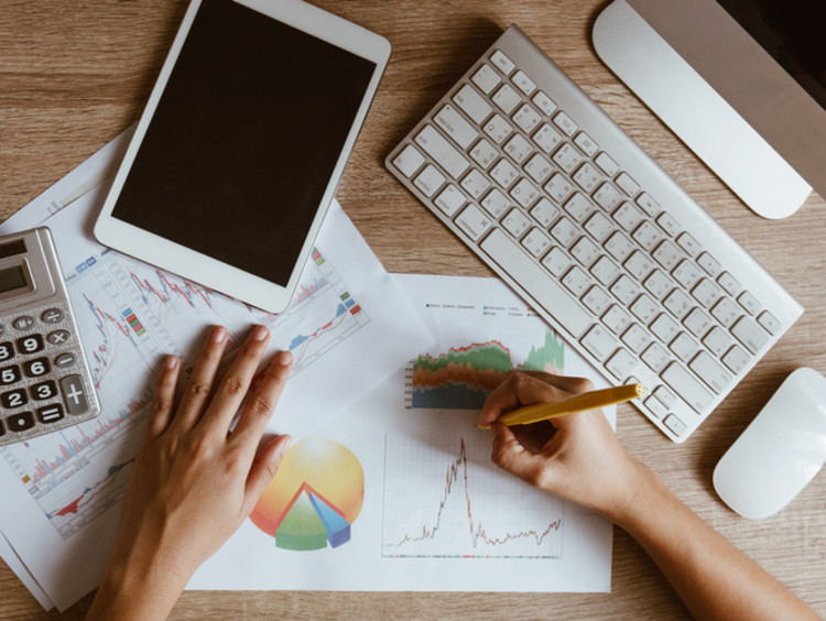 hands of an accountant with an mba working on documents