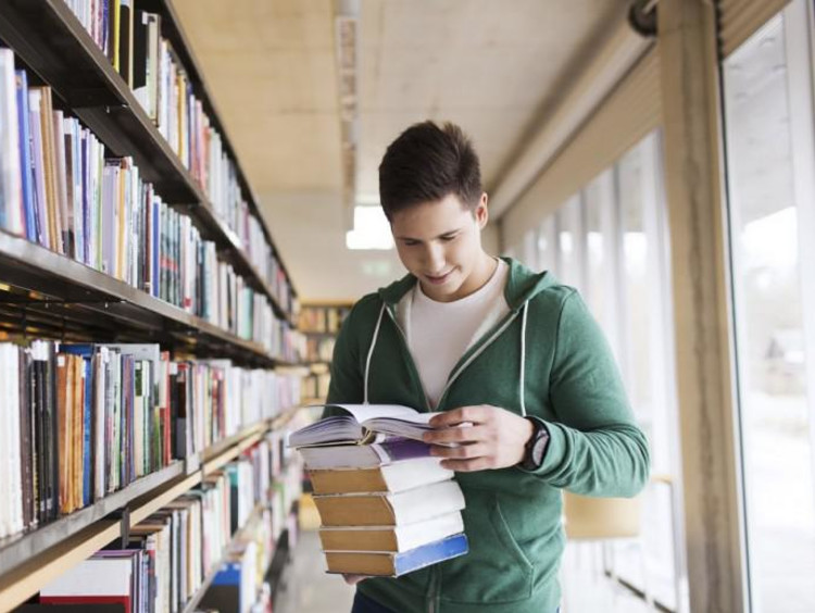 guy at the library reading books