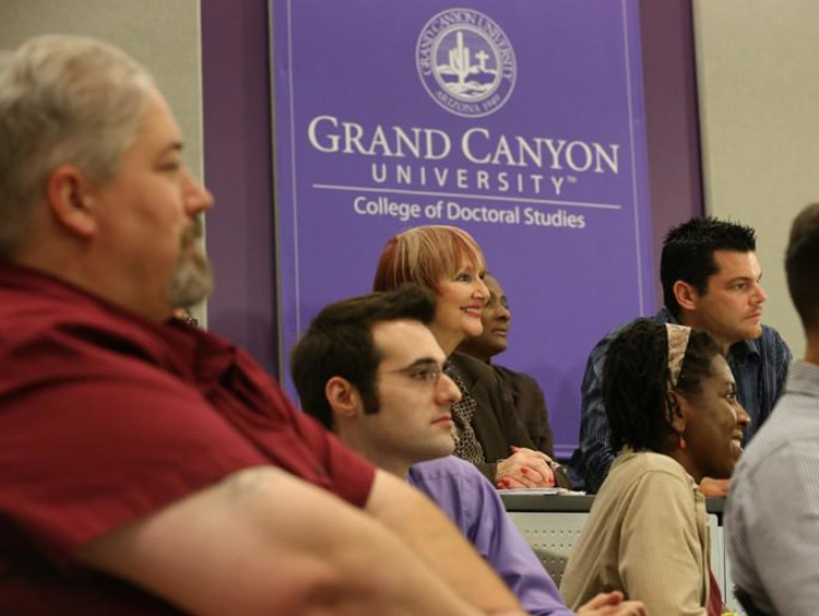 Doctoral students sit in a lecture